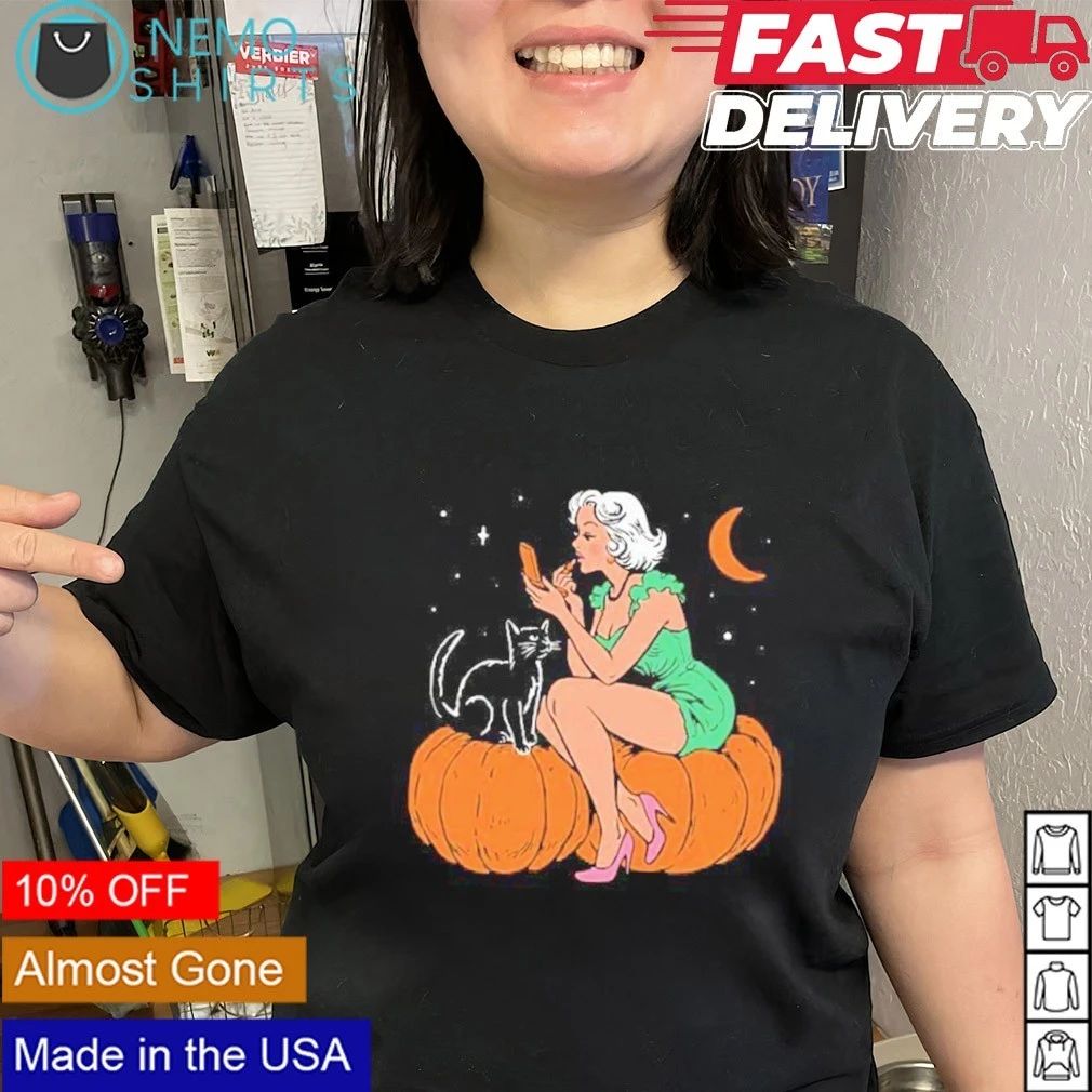 Pinup Girl Applying Lipstick on a Pumpkin with a Black Cat Halloween shirt