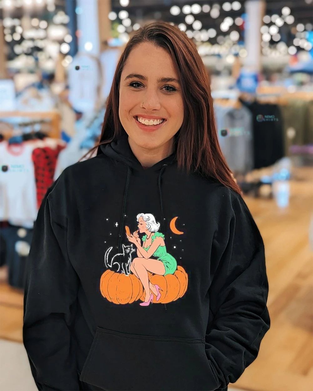 Pinup Girl Applying Lipstick on a Pumpkin with a Black Cat Halloween shirt