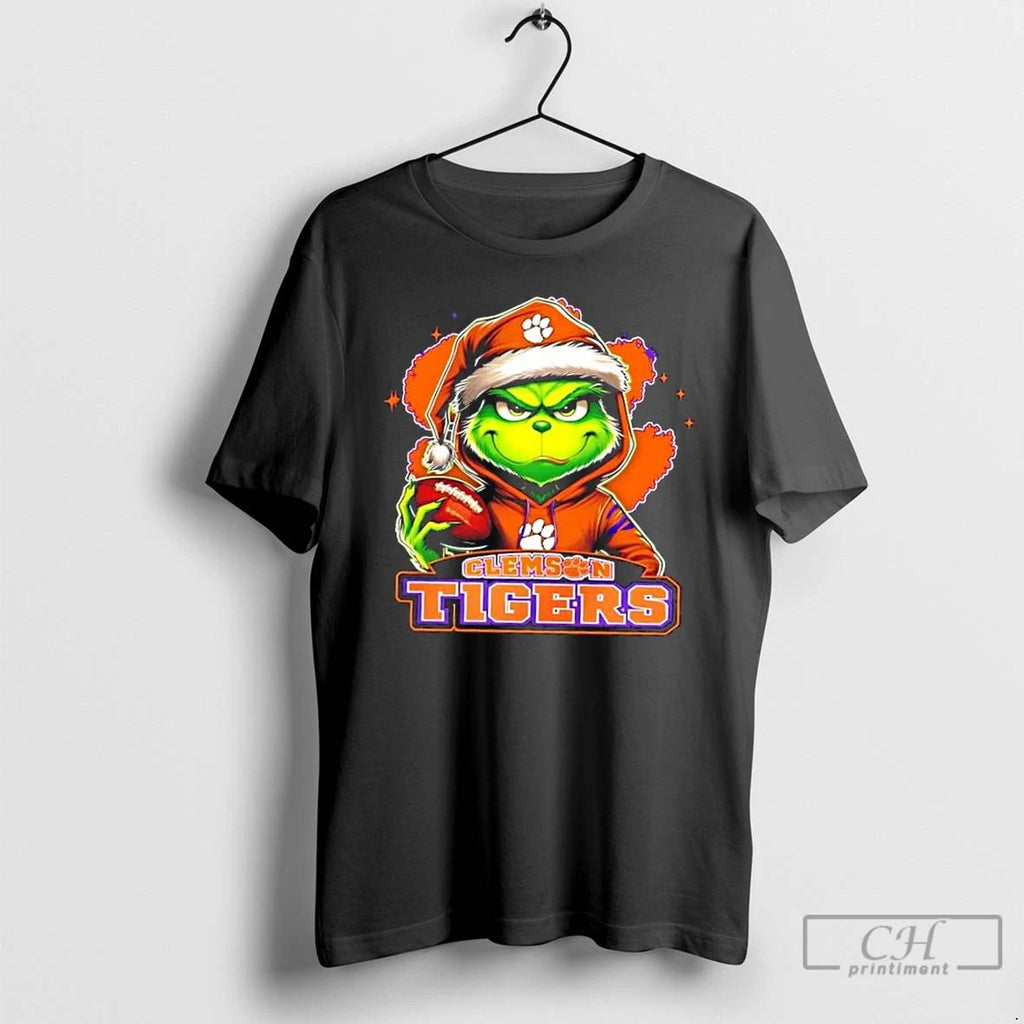 Premium Grinch Is Holding A Ball And Smiling At Clemson Tigers Fans Christmas T Shirts