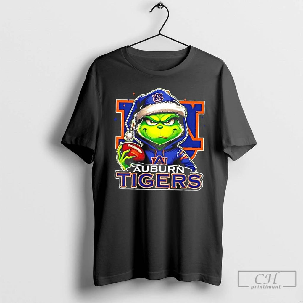 Premium Grinch Is Holding A Ball And Smiling At Auburn Tigers Fans Christmas T Shirts